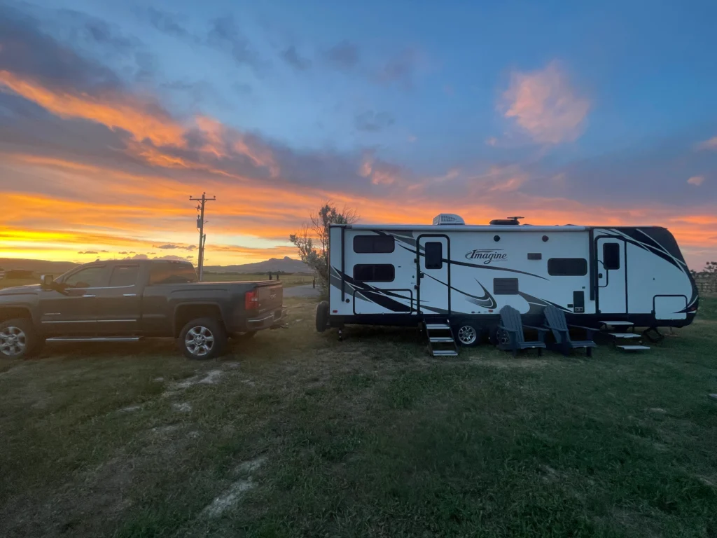RV Insurance Cost: Real Price Ranges by RV Type + Monthly Math Luxury Class A motorhome driving on scenic highway through mountains, representing higher RV insurance costs for motorized and high-value rigs